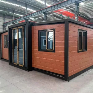 20ft double-wing expandable house with orange cladding in a workshop