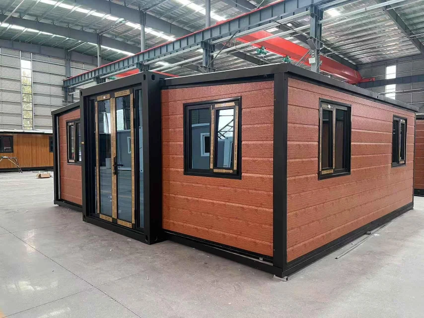 20ft double-wing expandable house with orange cladding in a workshop