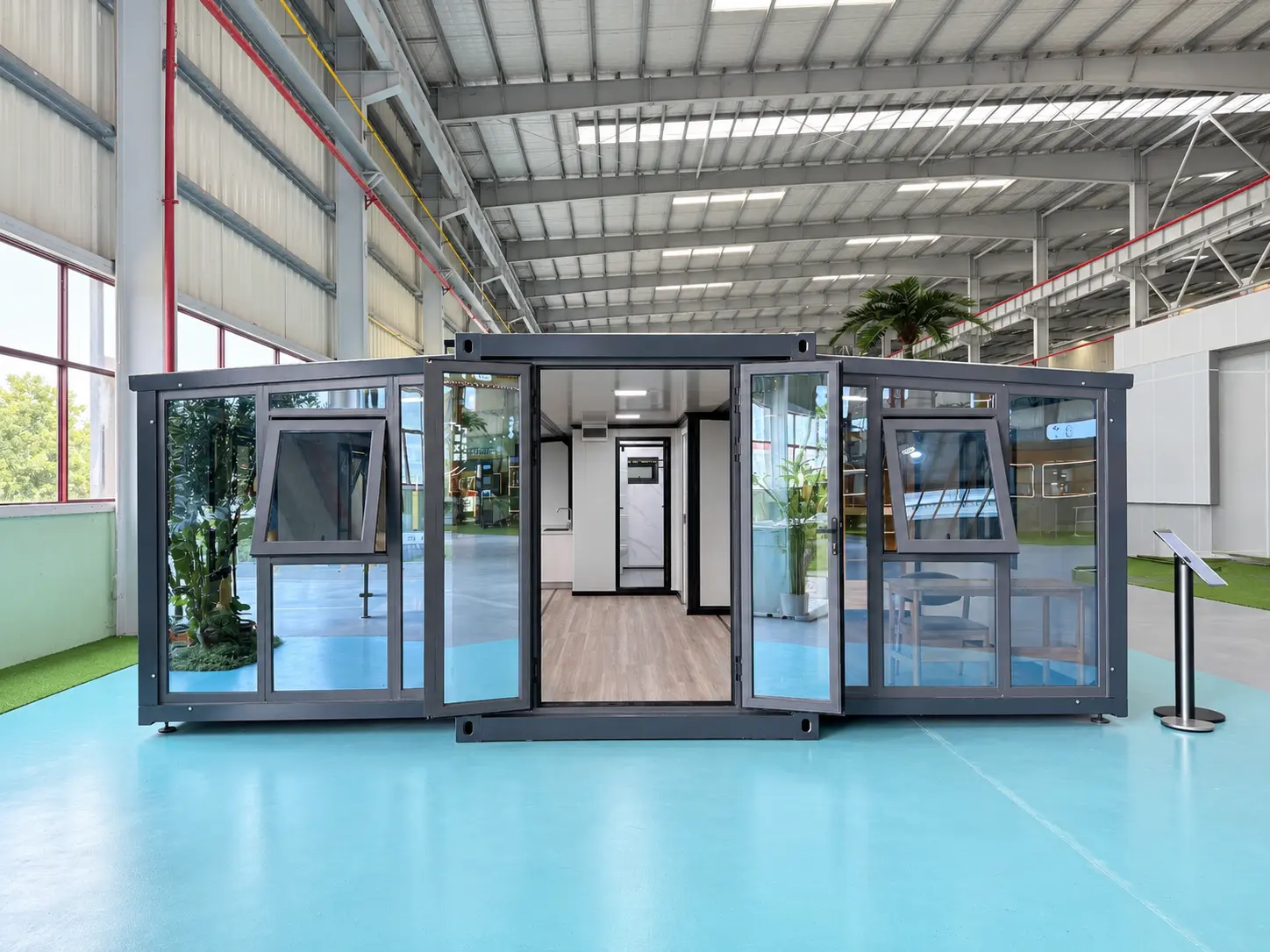 Front view of a 30ft expandable container house with dark exterior cladding, glass doors and opening windows.