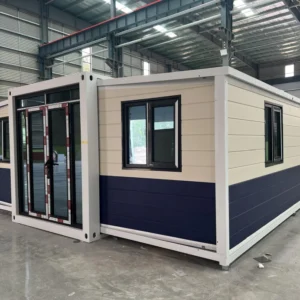 40ft double-wing expandable house with white and dark cladding in a workshop