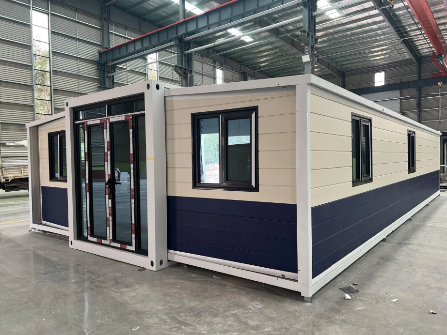 40ft double-wing expandable house with white and dark cladding in a workshop
