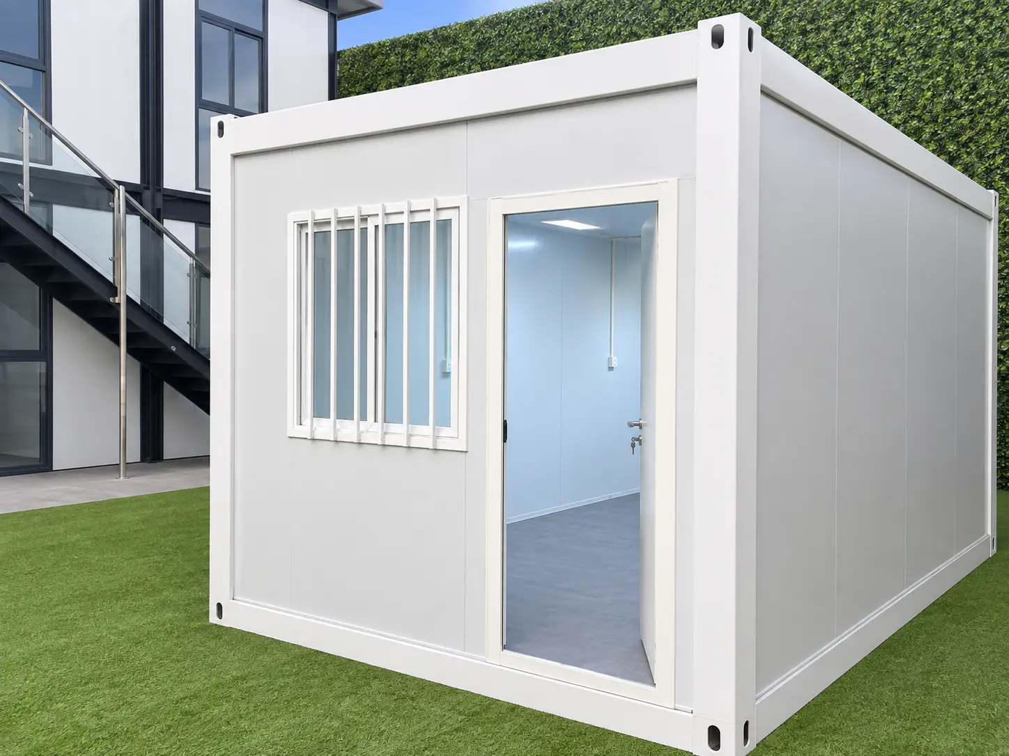 White detachable container house with a glass entrance door, security window and insulated wall panels.