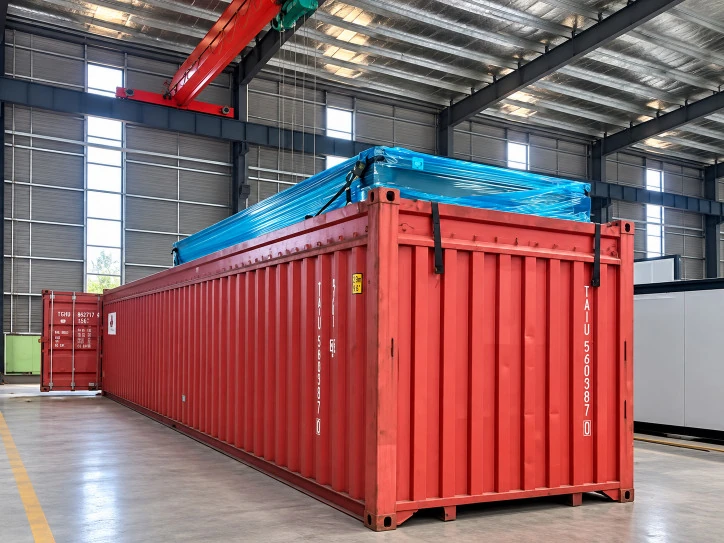 Wrapped expandable house being lowered into an open-top shipping container