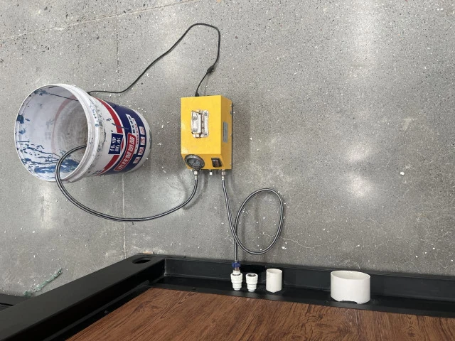 Water-testing pump connected to plumbing inside an expandable house