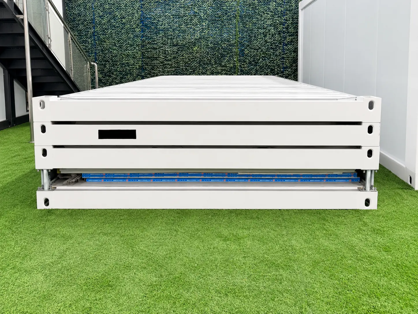 Flat pack container house frames compressed for efficient transport