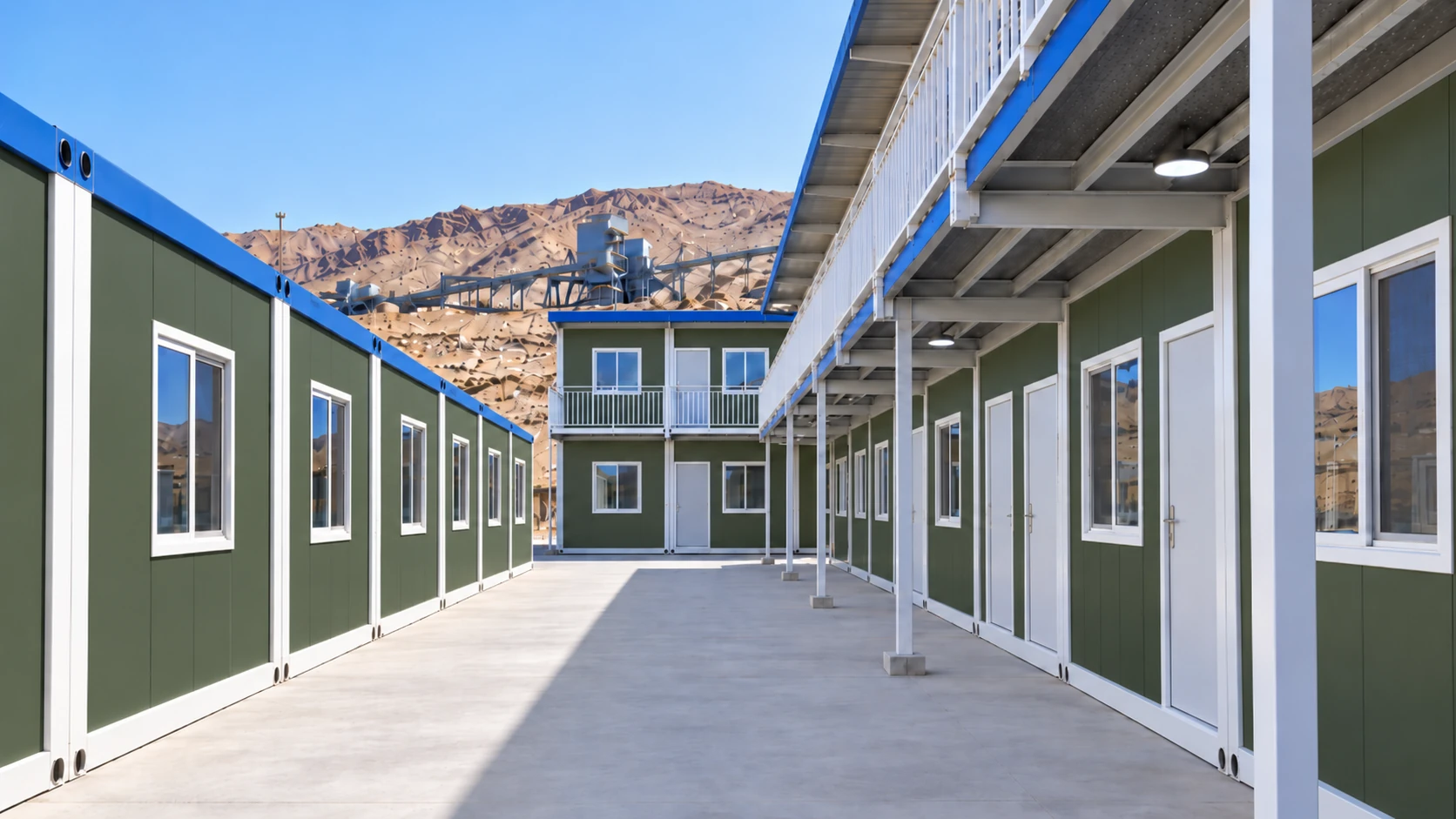 Ground-level corridor between modular accommodation buildings at a mining camp in Northwest China.