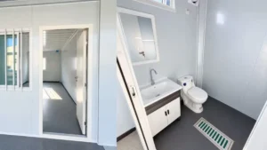 Modular bathroom with a washbasin, toilet and floor drain beside an adjoining room