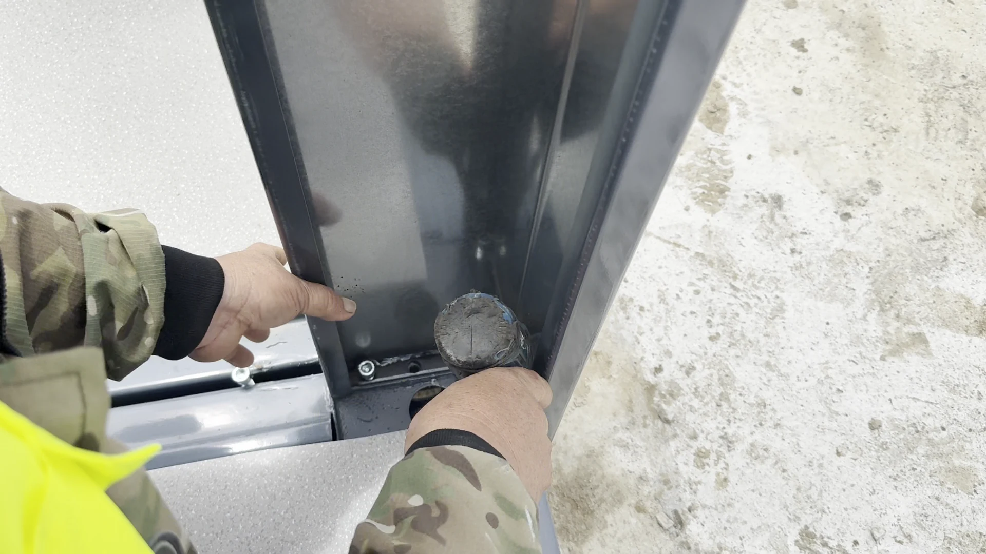 Close view of a grey flat-pack column connection at floor level