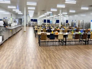 Configuration reference: Staff dining interior with tables, chairs and a food-service counter