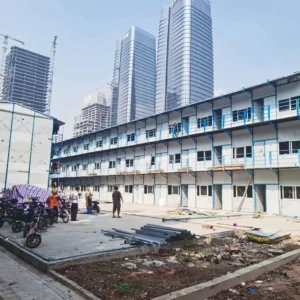 Three-storey T-House dormitory building with external walkways and staircases